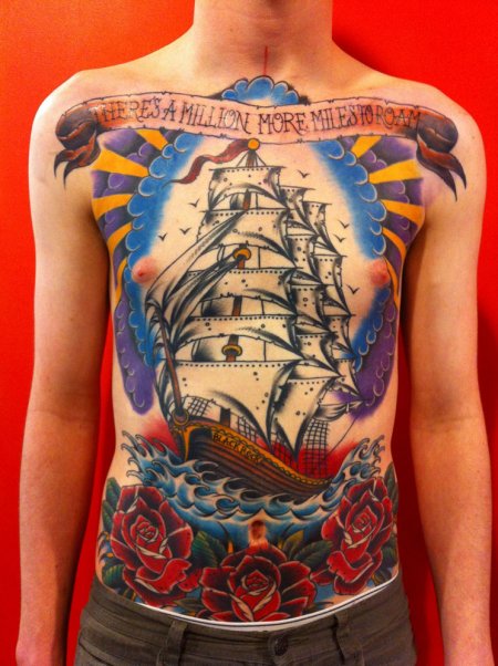 Traditional Ship With Roses And Banner Tattoo On Man Stomach