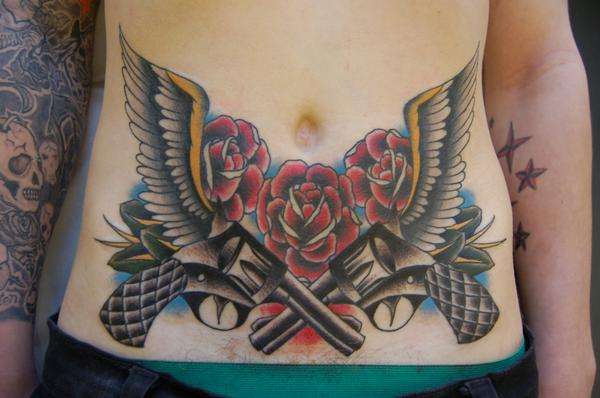 Two Crossing Gun With Wings And Roses Tattoo On Girl Stomach