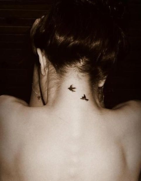Two Flying Birds Tattoo On Girl Back Neck