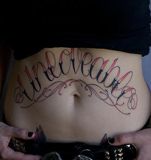 Unlovable Lettering Tattoo On Girl Stomach
