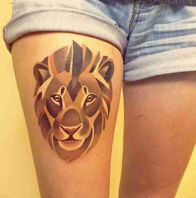 Abstract Lion Head Tattoo On Girl Thigh