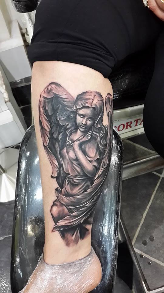 Beautiful Grey Ink Angel Tattoo On Leg by Engin Koc