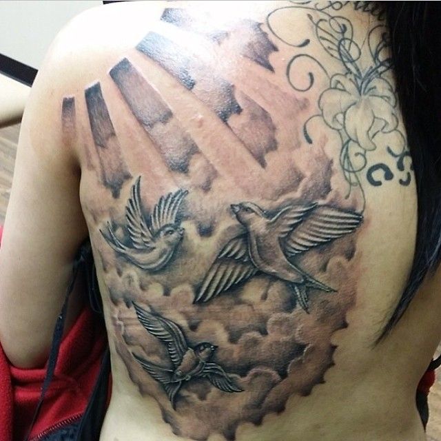 Black And Grey Flying Birds With Cloud Tattoo On Upper Back