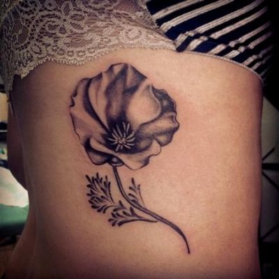 Black And Grey Poppy Flower Tattoo On Girl Side Rib