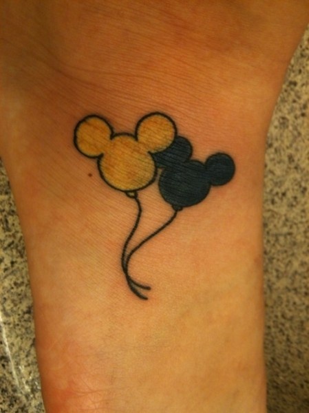 Black And Yellow Mickey Mouse Tattoo On Foot