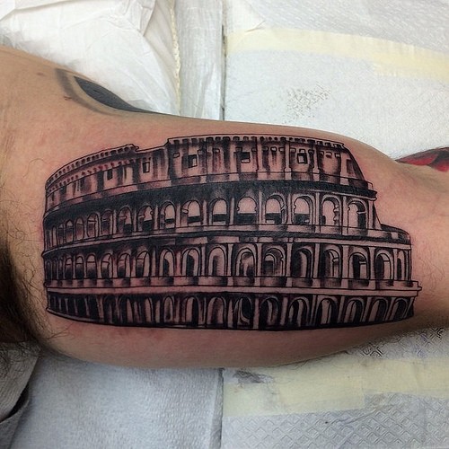 Black Ink Colosseum Tattoo On Bicep