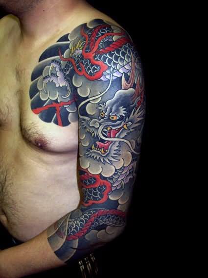 Black Ink Japanese Clouds With Dragon Tattoo On Man Left Half Sleeve