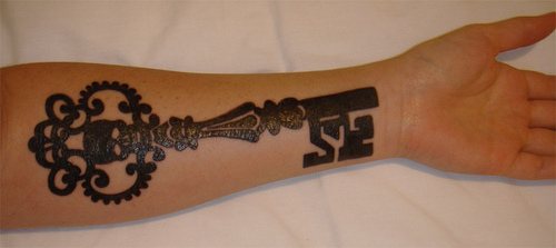 Black Ink Skeleton Key Tattoo On Left Forearm