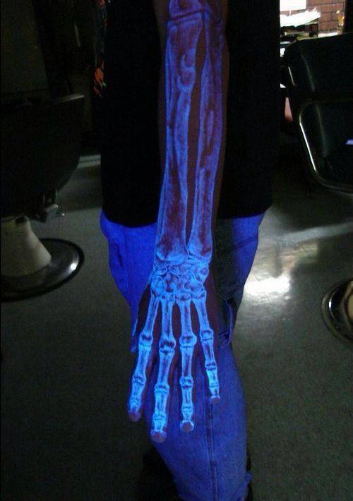 Black Light Arm Skeleton Tattoo On Left Sleeve