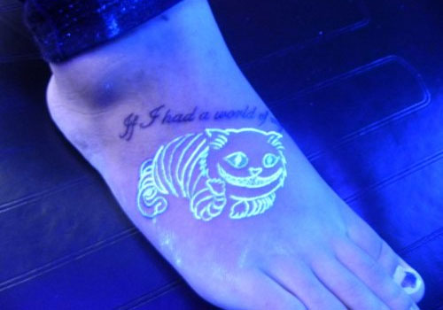 Black Light Cheshire Cat Tattoo On Right Foot