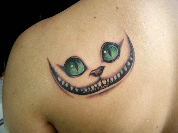 Blue Eyes Cheshire Cat Tattoo On Left Back Shoulder