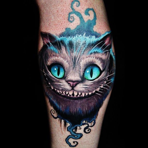 Blue Eyes Cheshire Cat Tattoo On Leg