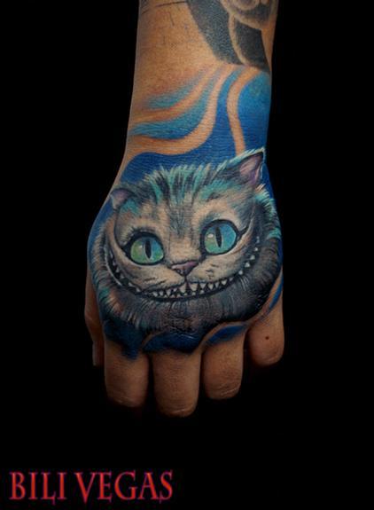 Blue Ink Cheshire Cat Tattoo On Left Hand