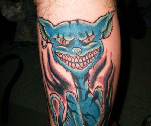 Blue Ink Cheshire Cat Tattoo On Leg