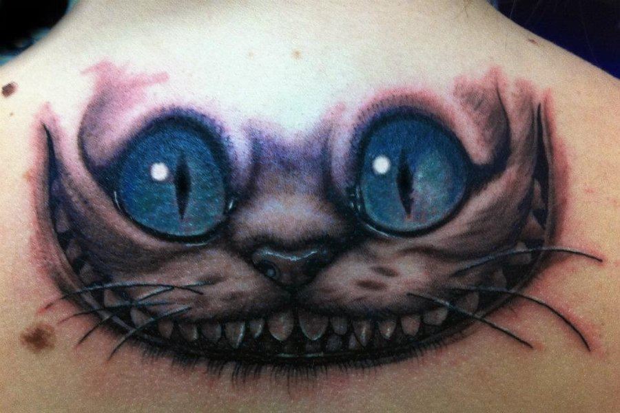 Cheshire Cat Face Tattoo On Upper Back
