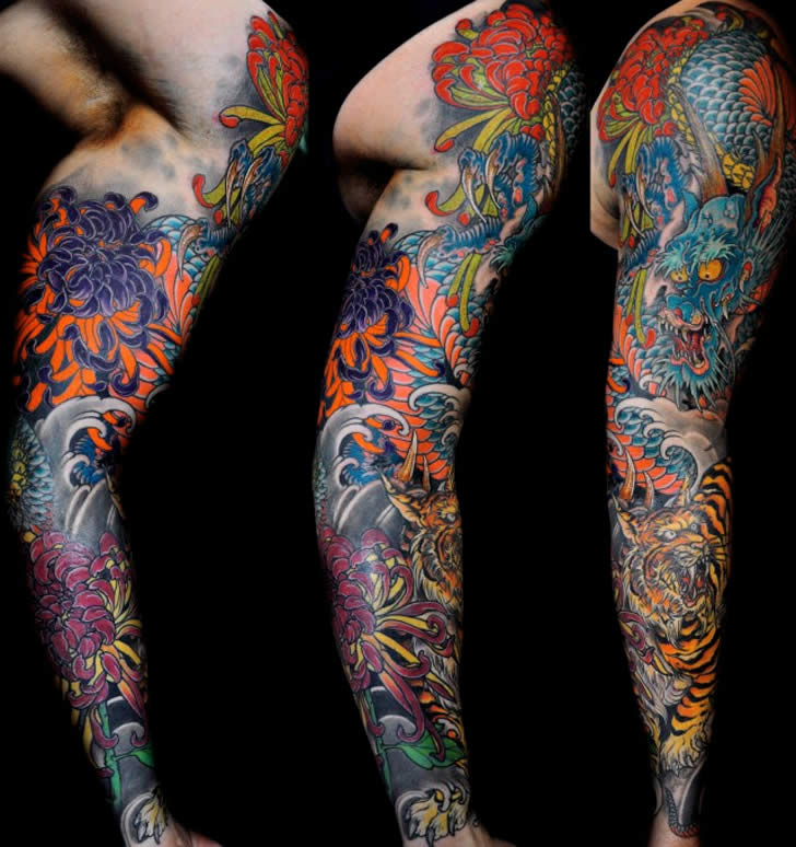 Colorful Dragon With Tiger And Flowers Tattoo On Man Full Sleeve By Federico Ferroni