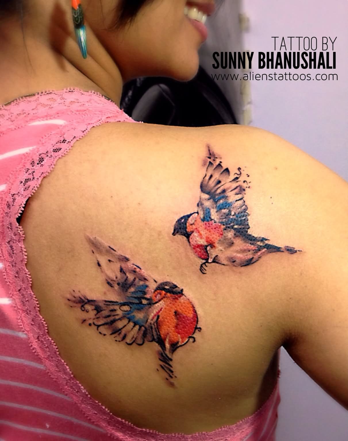 Colorful Two Flying Birds Tattoo On Girl Right Back Shoulder