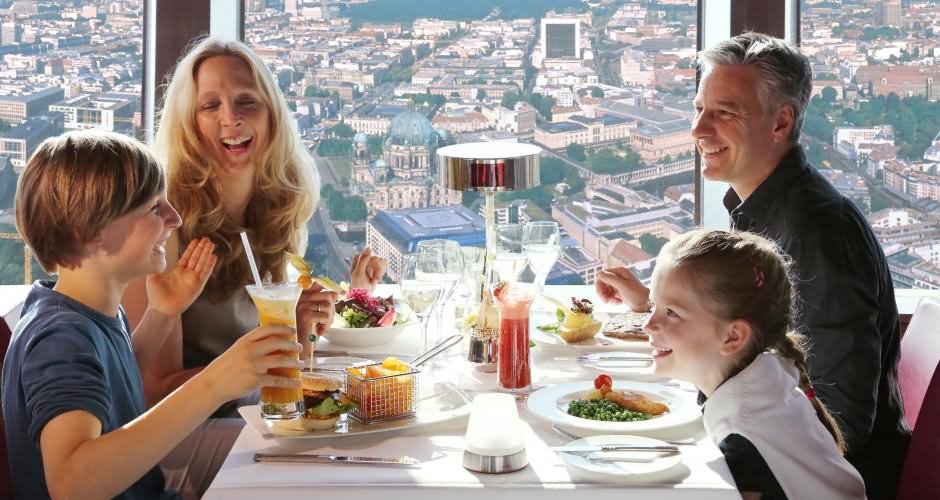 Family Enjoying Lunch at The Rotating Restaurant Inside The Fernsehturm Tower