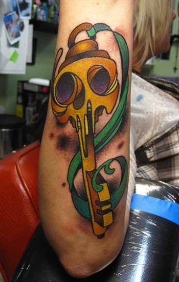 Green Ribbon And Skeleton Key Tattoo On Arm