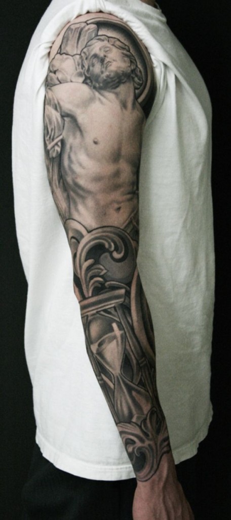 Grey Ink Jesus Face With Hourglass Tattoo On Man Right Full Sleeve