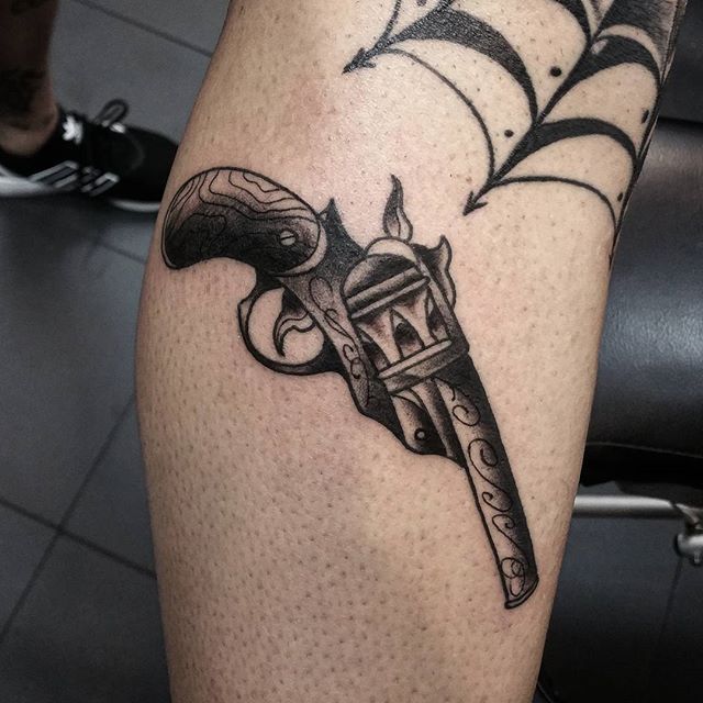 Grey Ink Revolver Tattoo On Leg by Midnightink