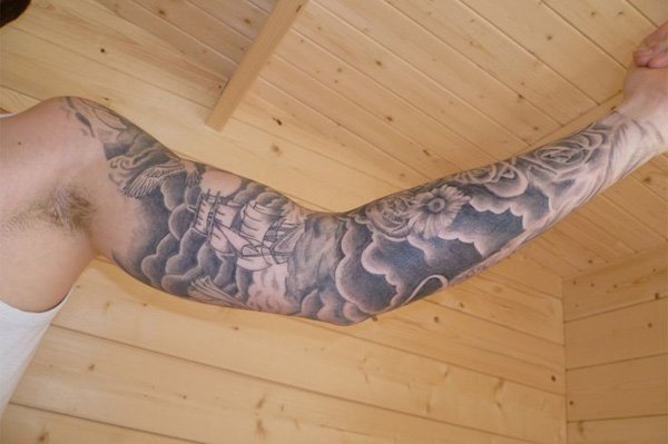 Grey Ink Ship With Clouds And Flowers Tattoo On Left Full Sleeve