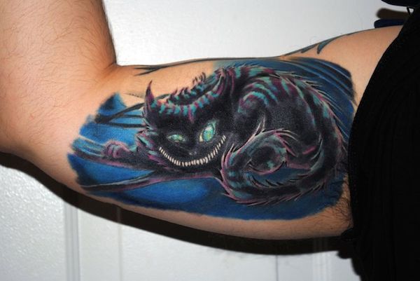 Inner Bicep Colored Cheshire Cat Tattoo