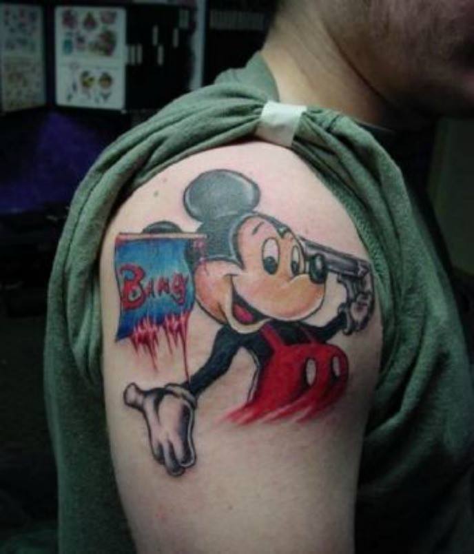 Mickey Mouse Shooting With Gun Tattoo On Shoulder