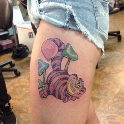 Mushrooms And Cheshire Cat Tattoo On Side Thigh