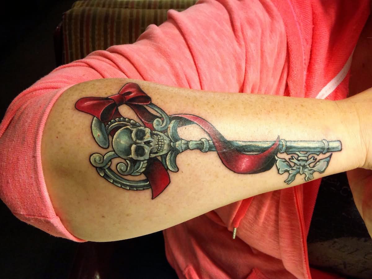 Red Ribbon And Skeleton Key Tattoo On Arm