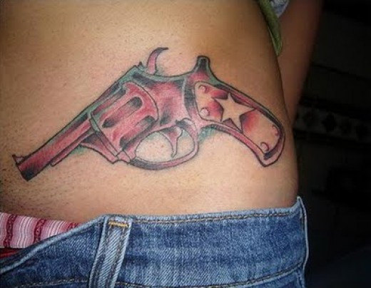 Revolver Tattoo On Girl Waist