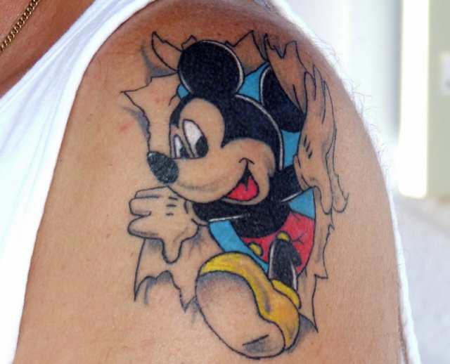 Ripped Skin Mickey Mouse Tattoo On Left Shoulder