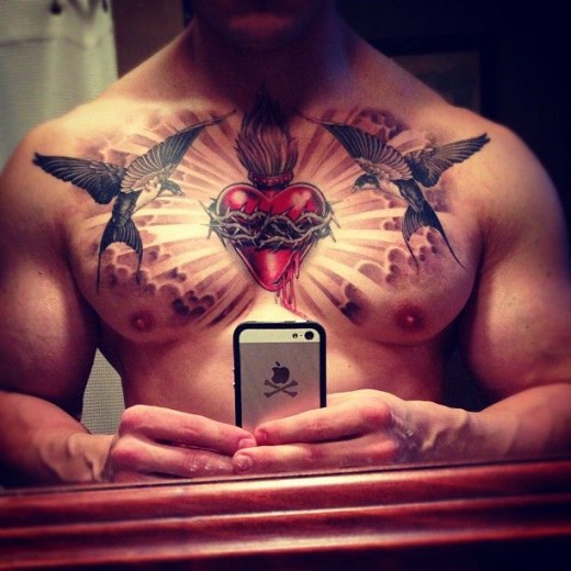 Sacred Heart With Two Flying Bird And Clouds Tattoo On Man Chest