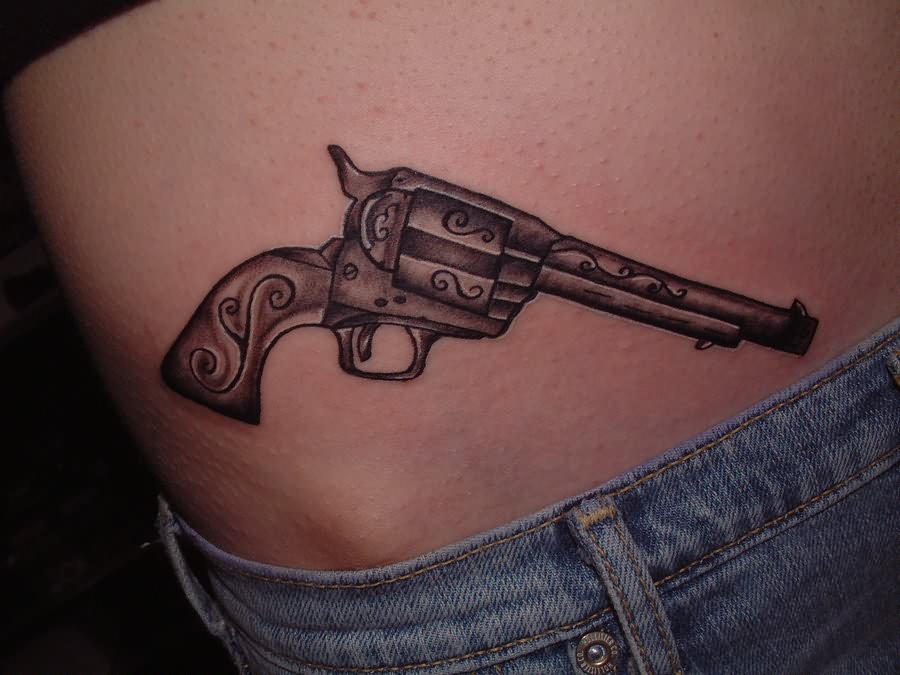 Simple Grey Ink Revolver Tattoo On Hip