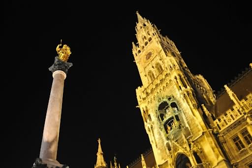 Statue Of Virgin Mary In Front Of The Neues Rathaus During Night