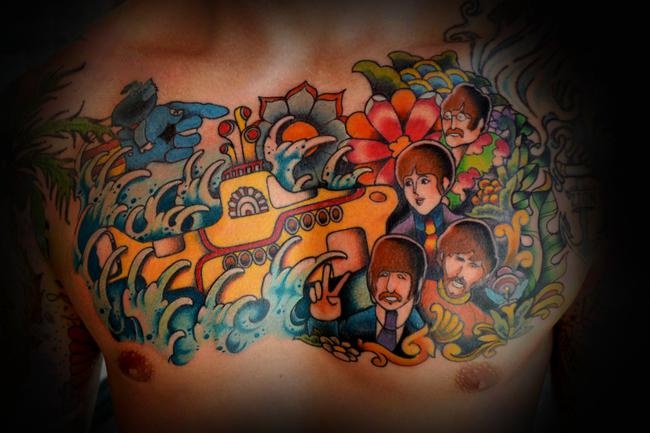 Traditional Submarine With Beatles And Flowers Tattoo On Man Chest