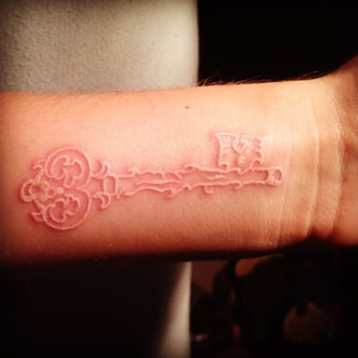 White Ink Skeleton Key Tattoo On Wrist