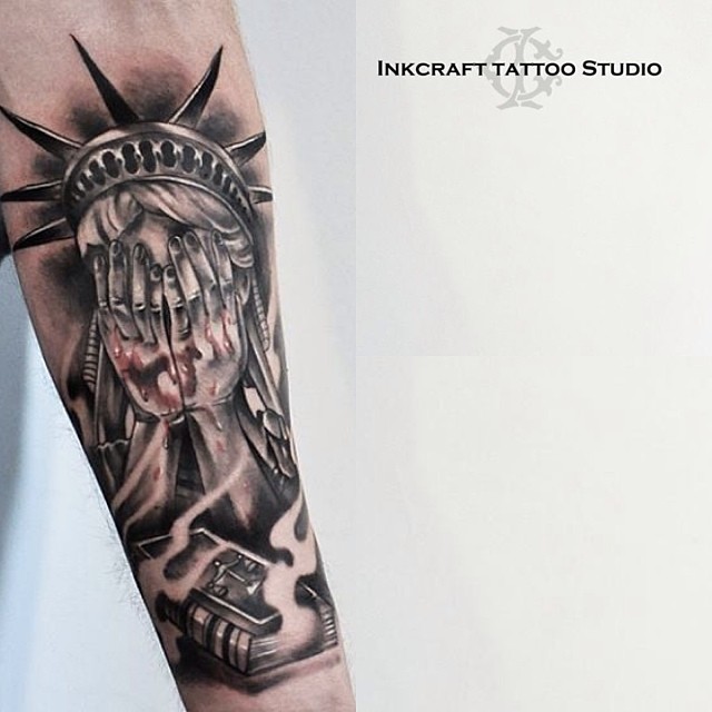 Attractive Crying Statue Of Liberty Hiding Face Tattoo On Forearm