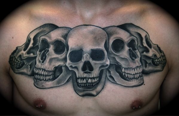 Black And Grey Horror 3D Skulls Tattoo On Man Chest