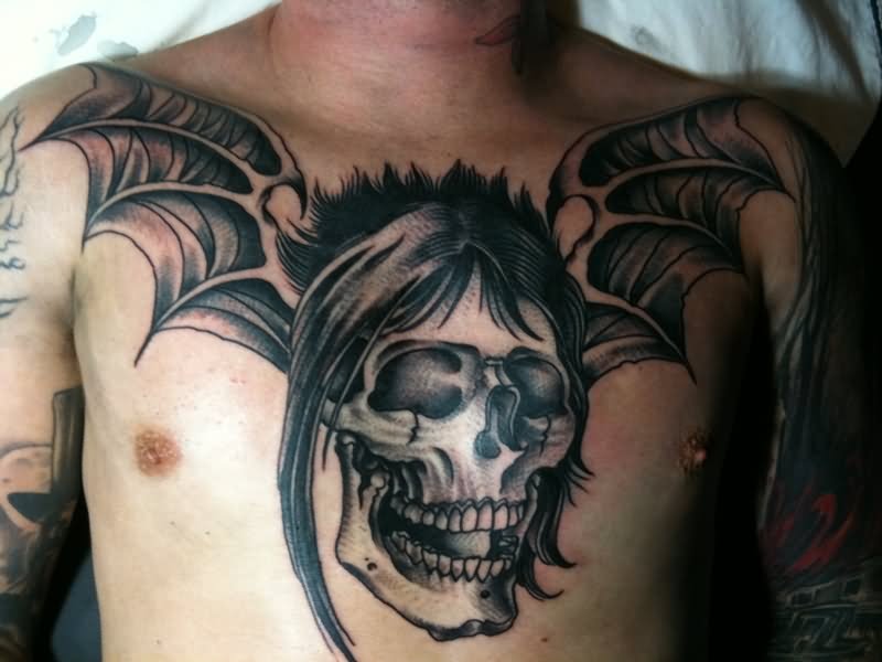 Black And Grey Horror Skull With Wings Tattoo On Man Chest
