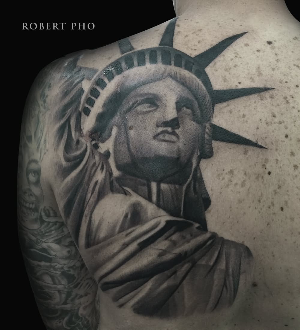 Black And Grey Statue Of Liberty Tattoo On Left Back Shoulder