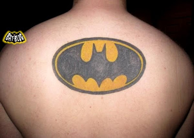 Black And Yellow Batgirl Logo Tattoo On Man Upper Back