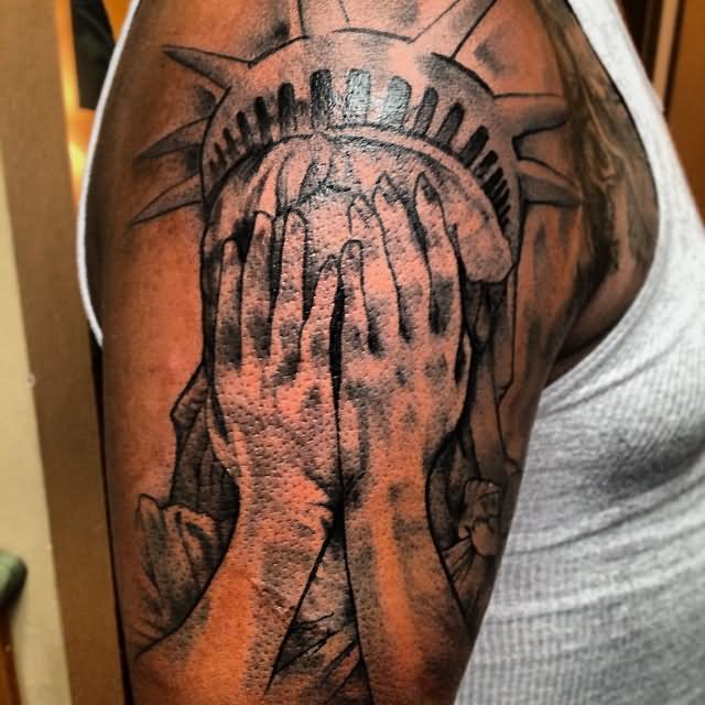 Black Ink Crying Statue Of Liberty Hiding Face Tattoo On Right Shoulder