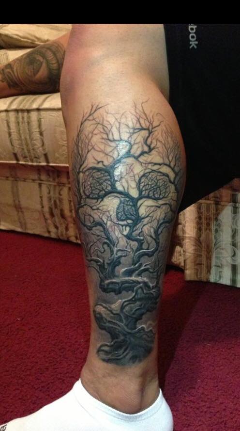 Grey Ink Autumn Tree Without Leaves And Skull Tattoo On Leg