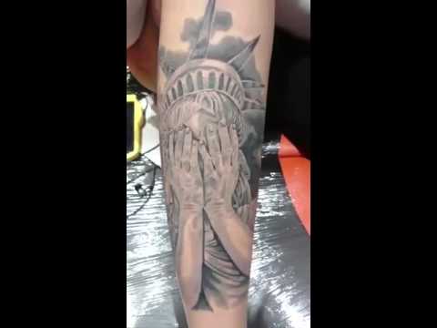 Grey Ink Crying Statue Of Liberty Tattoo Design For Arm