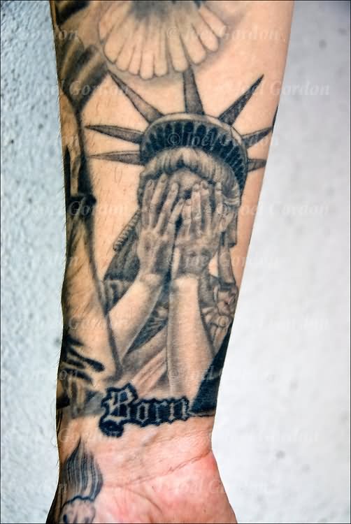 Grey Ink Statue Of Liberty Hiding Face Tattoo On Wrist