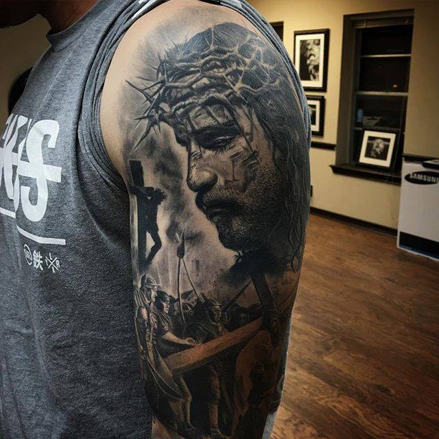 Grey Jesus Head Tattoo On Left Half Sleeve
