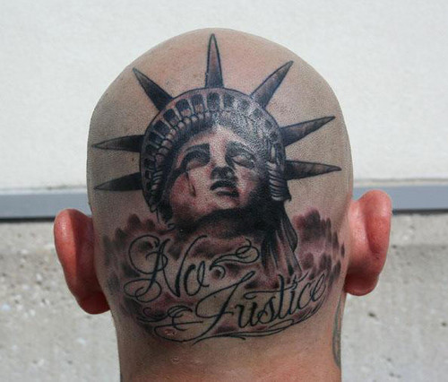 No Justice – Black Ink Crying Statue Of Liberty Head Tattoo On Man Head
