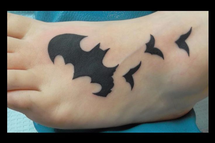 Silhouette Batgirl Symbol With Flying Bats Tattoo On Left Foot