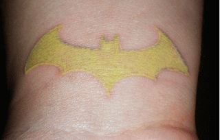 Yellow Batgirl Logo Tattoo Design For Wrist